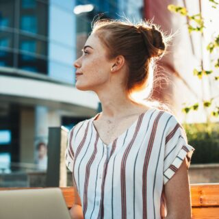 woman outside in the sunlight looking in the distance