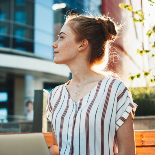 woman outside in the sunlight looking in the distance