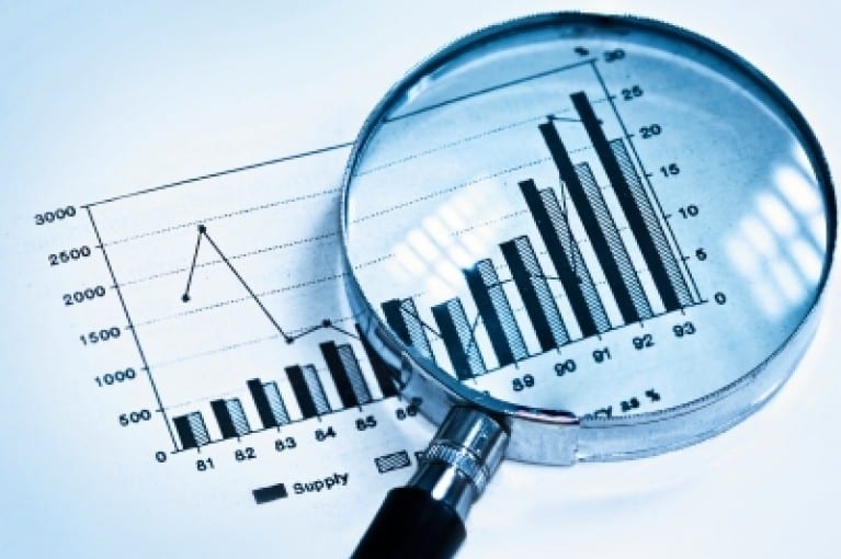 magnifying glass over a chart on a paper