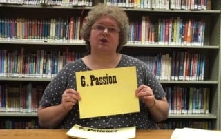 librarian holding a sign that says passion