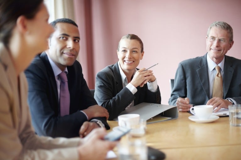 people sitting around a boardroom meeting